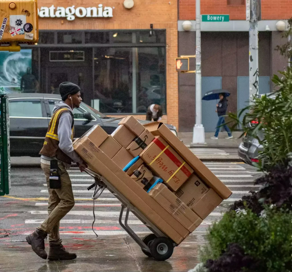 A professional delivery man with packages. he is displaying goods and service supply chain in one picture