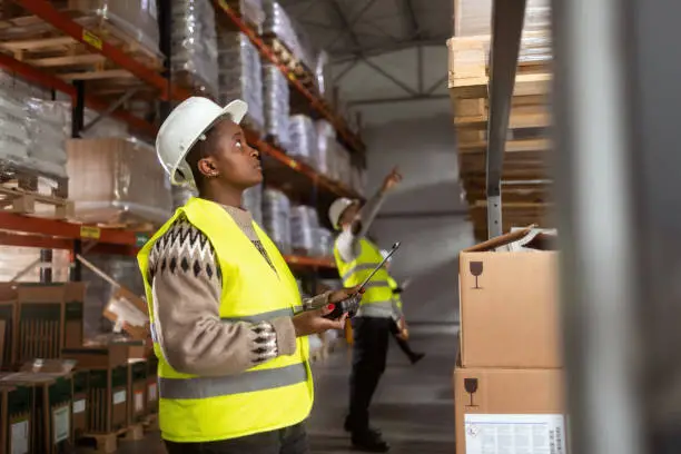 Two warehouse staffs organizing their ware house through slotting